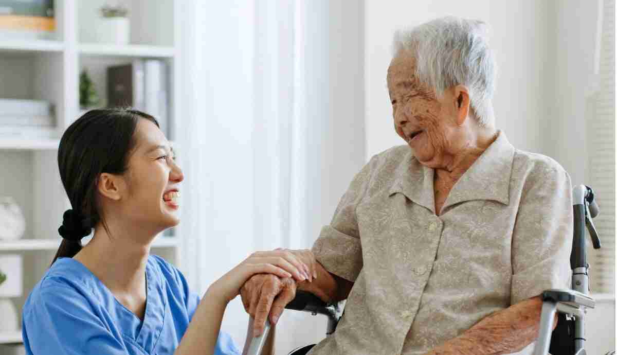 smiling aged care worker with happy older person smiling aged care worker with happy older person